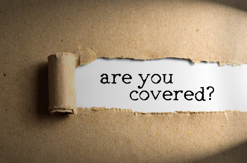 text under ripped paper that says “are you covered?”